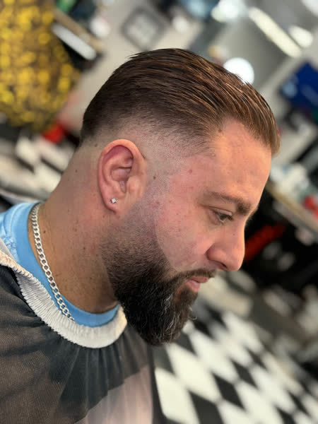 Slick-back with a skin fade and shaped beard at Salt City Barber Shop in Liverpool, NY