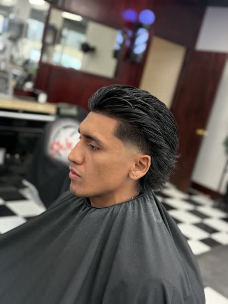 Slicked-back pompadour with a low taper at Salt City Barber Shop in Liverpool, NY