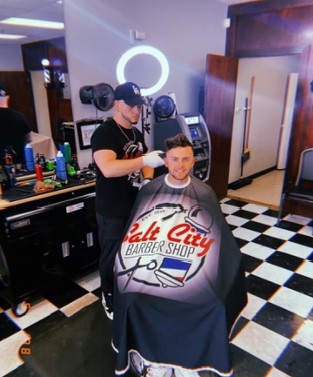 Client in a Salt City Barber Shop cape getting a haircut